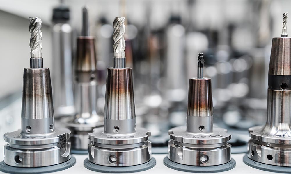CNC manufacturing facility showcasing a selection of various drill heads for both rotary and cubic machining processes.